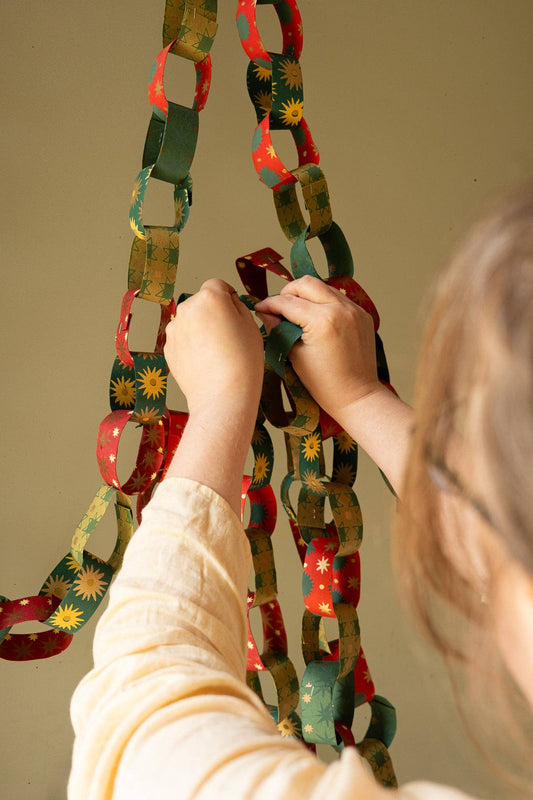 Recycled festive paper chain strips, hand-printed double-sided, eco-friendly decoration kit.