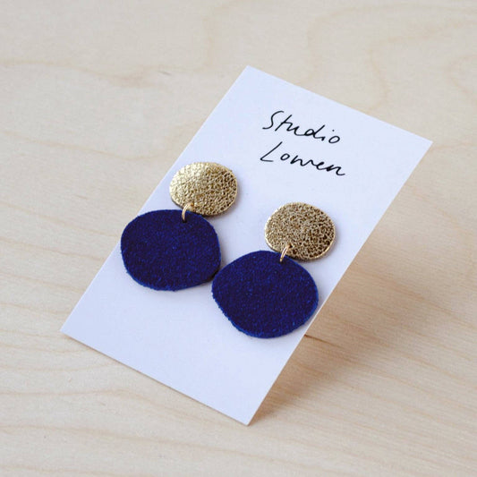 Close-up of Bili Pop suede and shimmer gold leather drop earrings, showing texture.