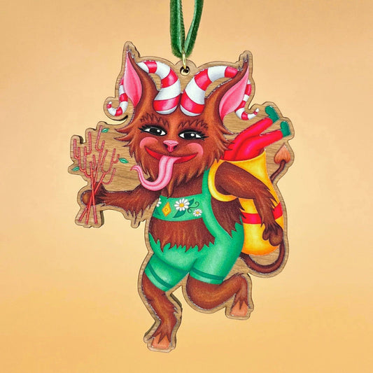 Krampus wooden Christmas tree decoration featuring Teddy & Kipling illustration, sustainably certified cherry wood, gold-plated ring, and dark green velvet ribbon