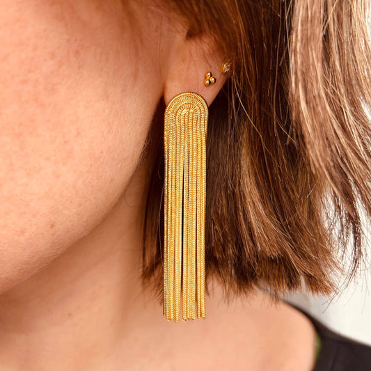 Model wearing Little Nell Gold Plated Tassel Earrings, elegant statement