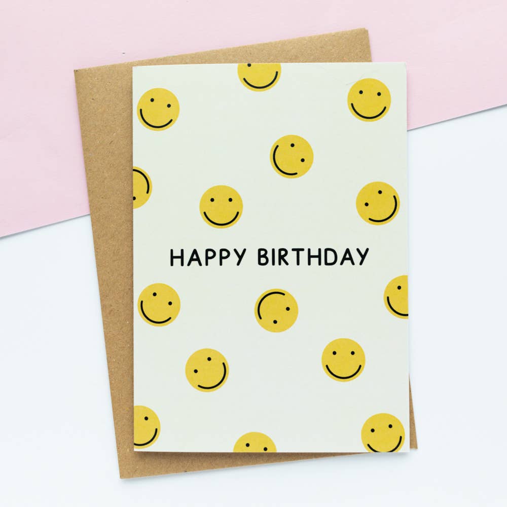 Yellow A6 greeting card featuring a happy smiley face and ‘Happy Birthday’ text, made from 100% recycled cardstock and printed with vegetable inks.