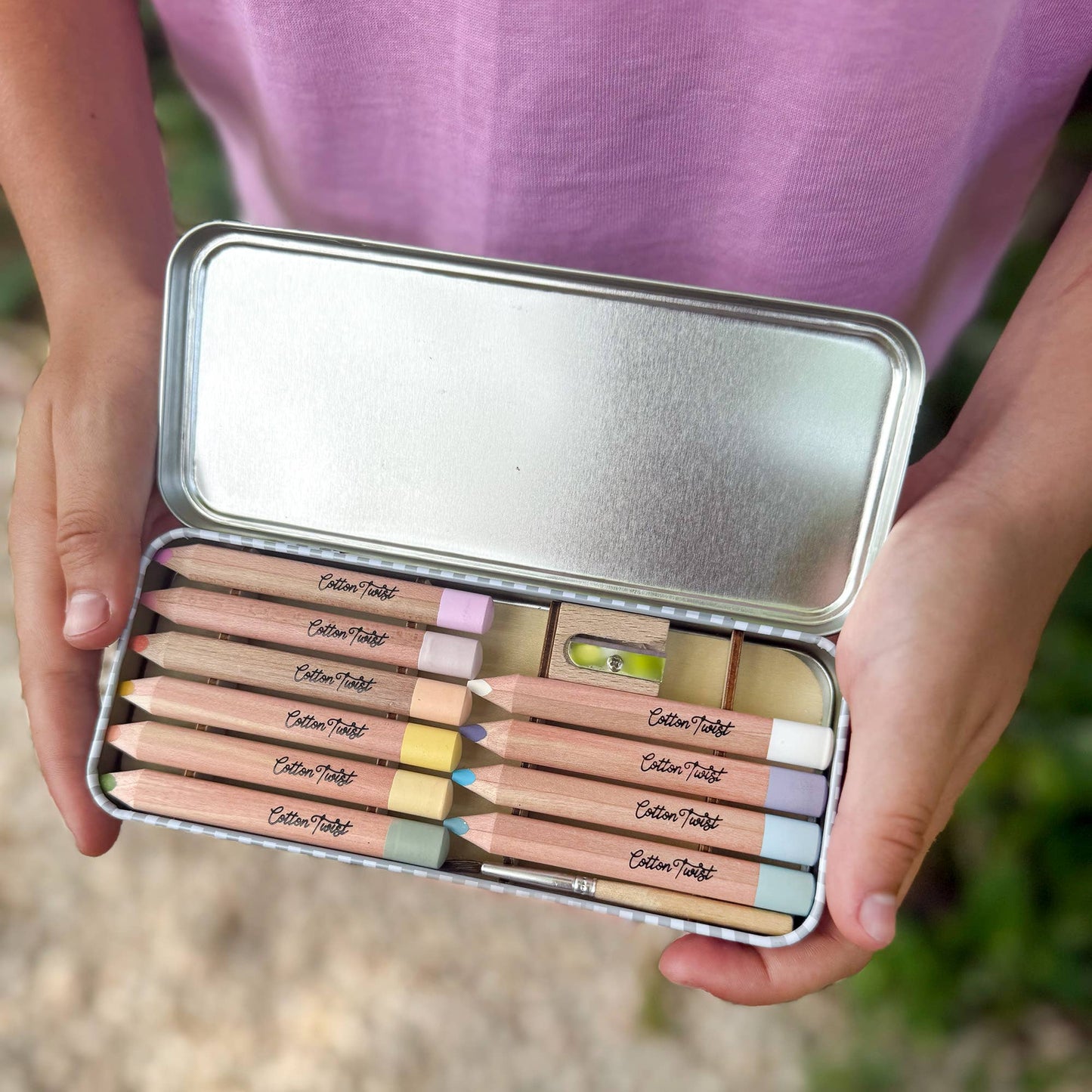 Cotton Twist Pastel Watercolour Pencils Set open tin with pencils, paintbrush, and sharpener.