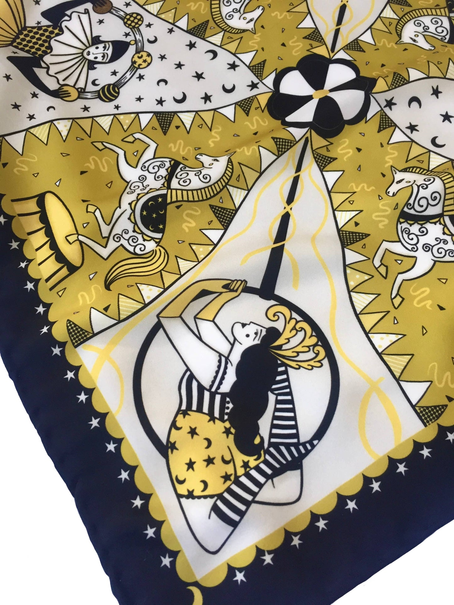 Eco silk twill pocket square with original Night Circus print by Su Owen; features Pierrot juggler, aerialist, horses, moons, and stars. Golden yellow, ivory, and dark chocolate colours. Made from 100% recycled polyester.
