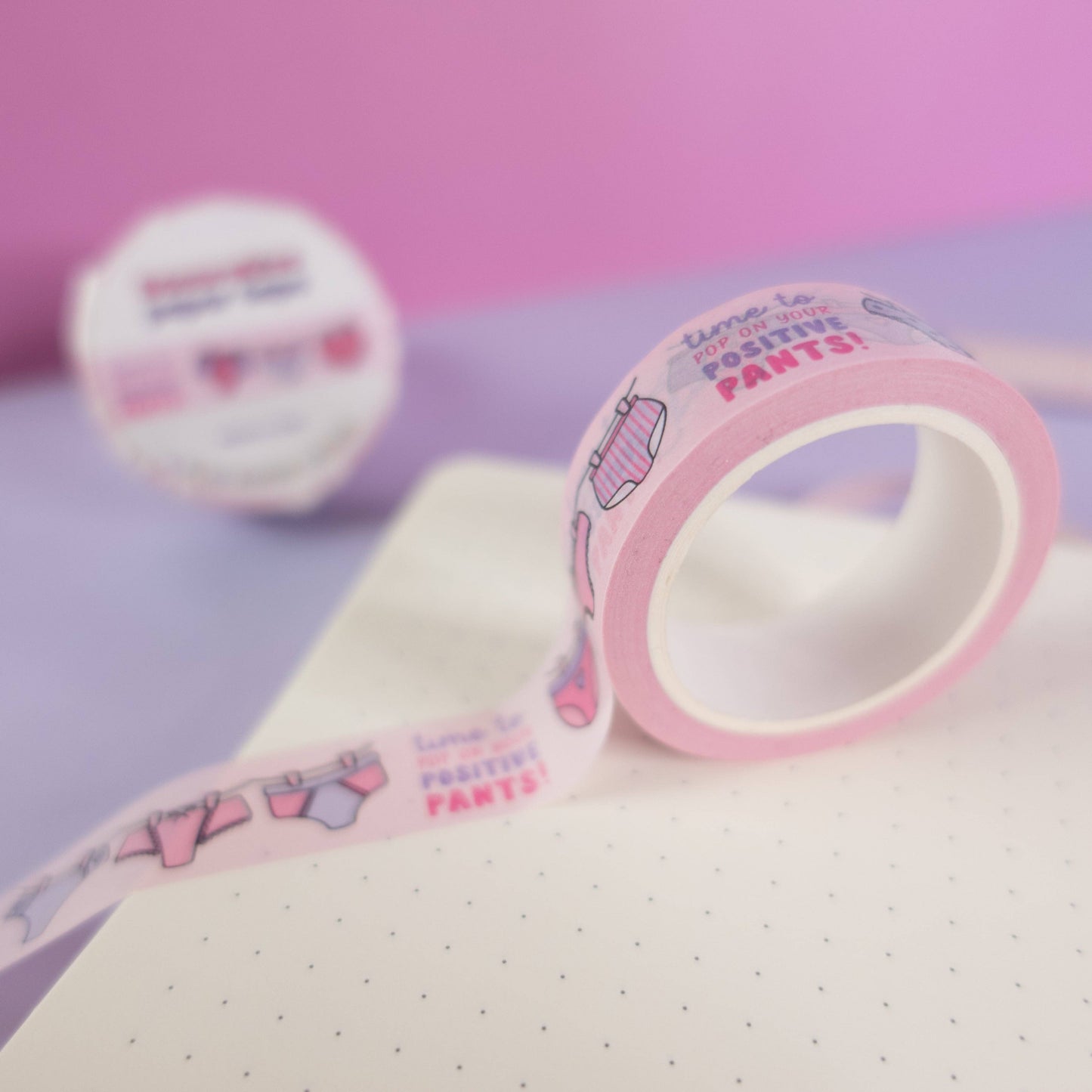 Pink and purple patterned pants washi tape with “pop on your positive pants” message and eco-friendly paper packaging—perfect for uplifting journaling and craft projects.