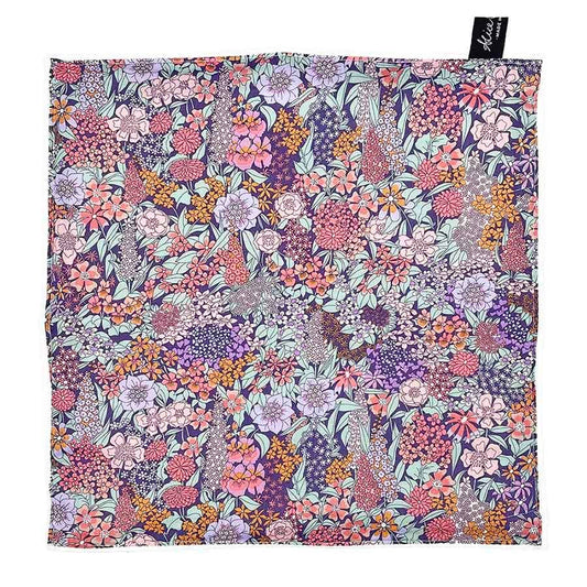 Reusable Liberty Ciara Lavender face cloth folded, showcasing the vibrant floral pattern and soft texture.