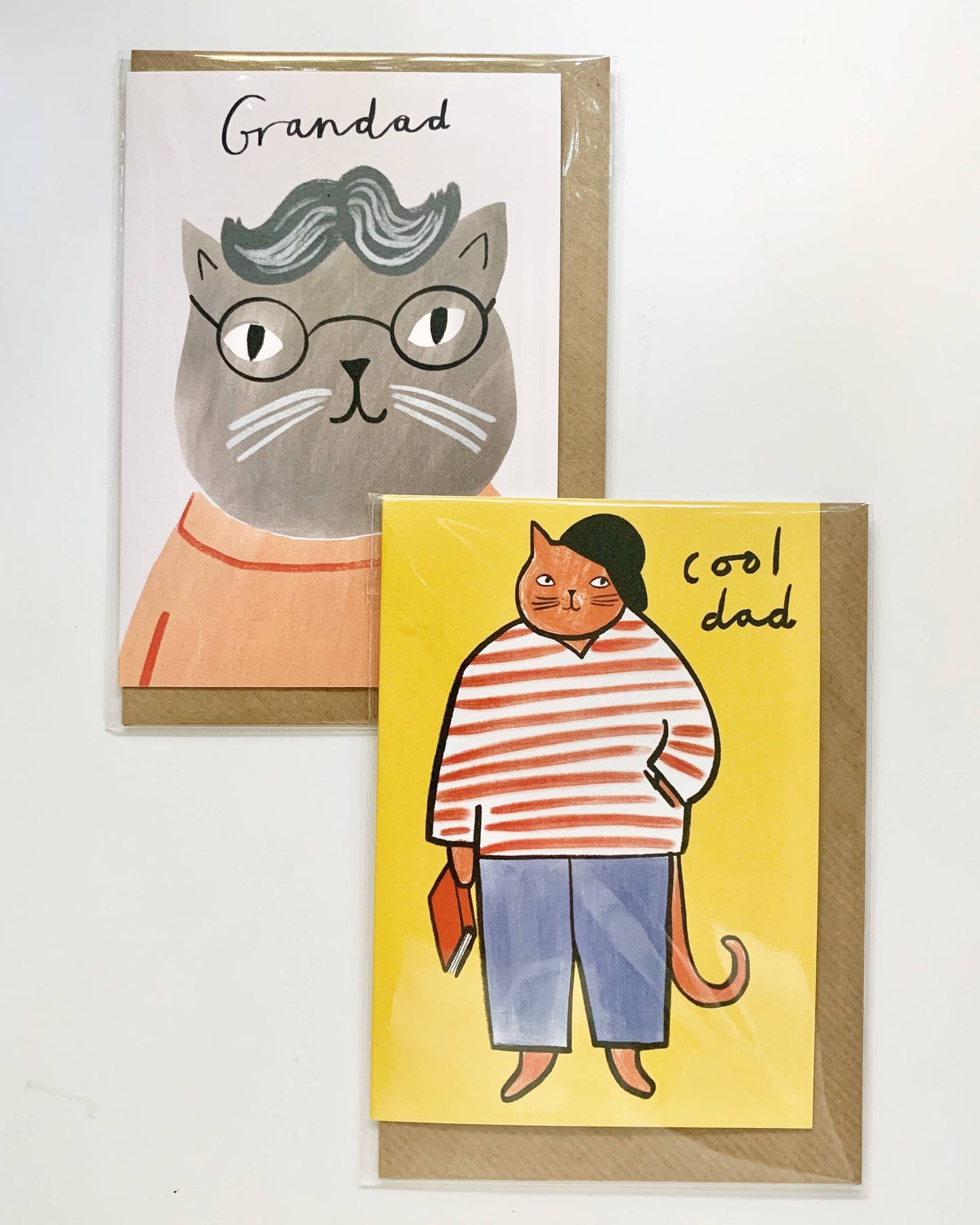 Two greeting cards with cat illustrations on a white background