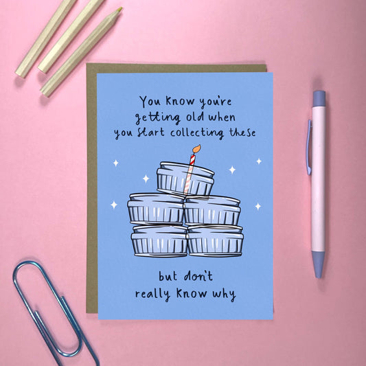 Close-up of funny Gu Pots birthday card with Kraft envelope