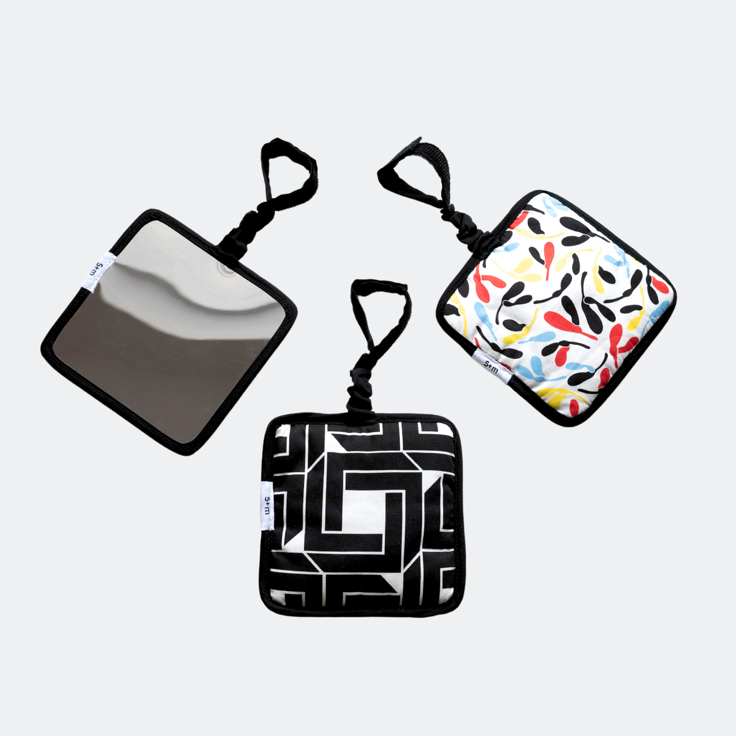 Triple pack of Etta Loves sensory hanging squares in fern/sycamore, chequers/illusion, and dalmatian/mirror designs, approx 13cm, with sensory features and velcro attachments.