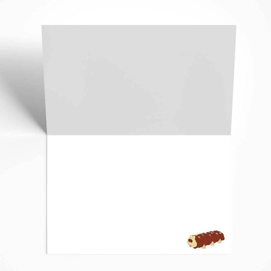 Inside of the birthday card showing a small, cute illustration of Colin the Caterpillar cake in the corner.