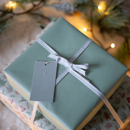 Sustainably sourced green kraft wrapping paper with fine silver lines
