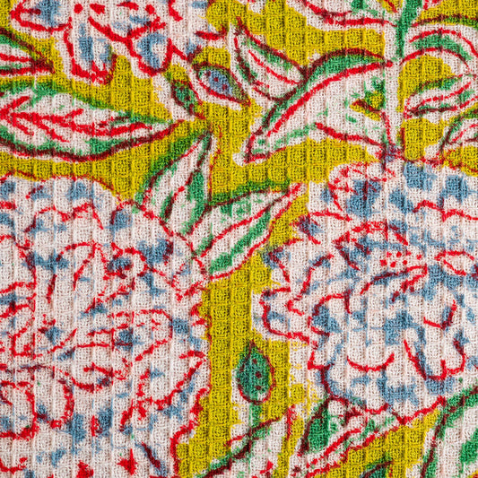 Close up of hand block printed olive and ivory floral motifs