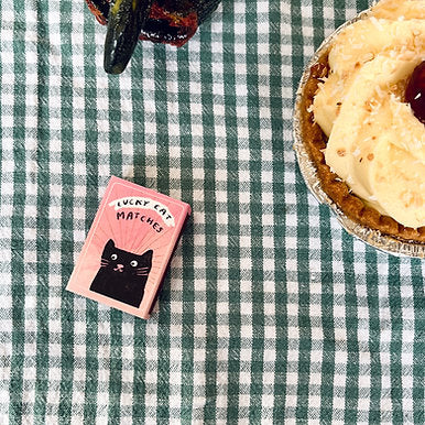 Lucky Cat Matches matchbox, showing the eco-friendly 100% recycled card material and unique black cat artwork.