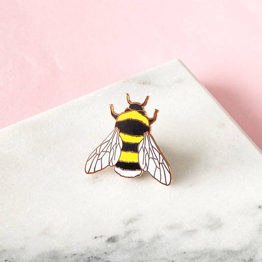 Based on one of Sarah Frances's original watercolour illustrations, this Bee Enamel Pin is perfect for any bee lovers! It will add some serious pin flair to any jacket, bag or cardigan. Made with shiny rose gold metal and hard enamel, the pin measures 1 inch (25mm) at it's widest point. It has a black rubber clutch on the back and will be presented on a small cardboard backer.