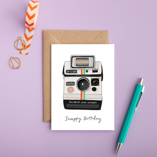 Close up of the hand-drawn instant camera illustration on premium card