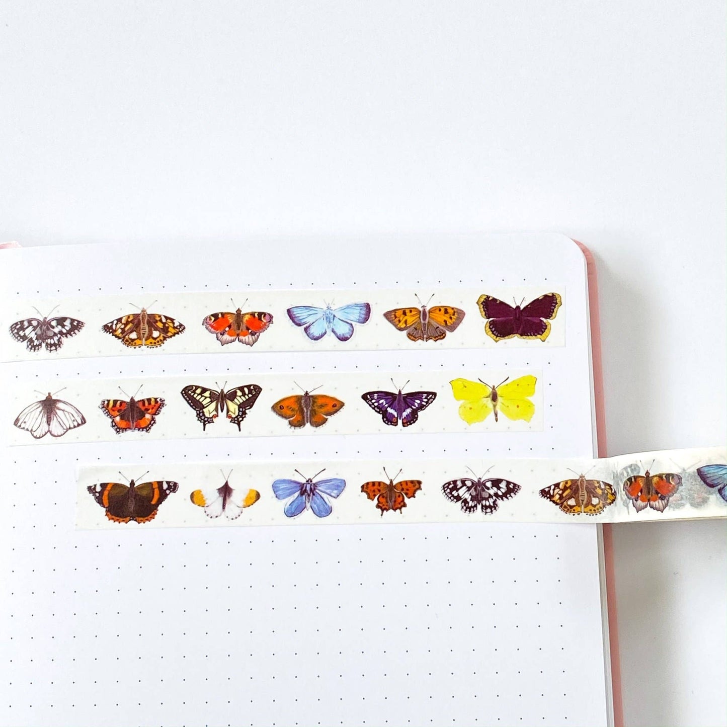 Close-up of eco-friendly British butterfly washi tape, featuring a pattern of various colourful butterflies