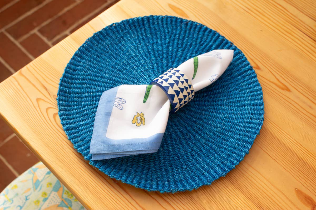 Hand carved blue triangle soapstone napkin ring, crafted in Kisii, Kenya with natural colour variation, African artisan-made dining accessory.