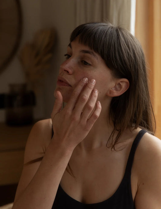 Close-up of Land & Water Daily Serum bottle with active ingredients sea buckthorn and hyaluronic acid.