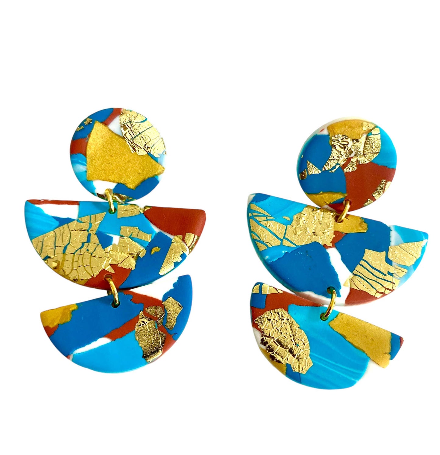 Large polymer clay statement earrings with turquoise, teal, white and terracotta colours, and splashes of gold leaf. Nickel Free. The earrings are in three parts a round section with a small odl hoop connecting it to a large semi circle and then another small gold hoop connecting it to a smaller semi circle. So the earring dangles below the ear lobe.