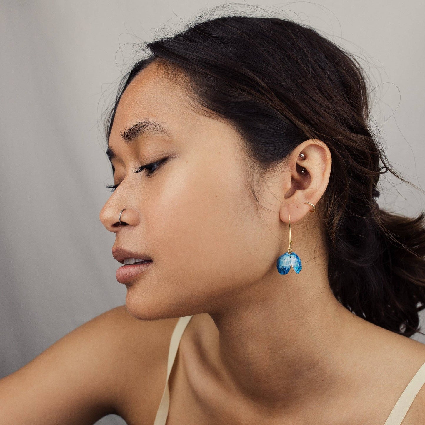 Model wearing Bluebell earrings from Forget Me Not & Green, highlighting their elegant drop