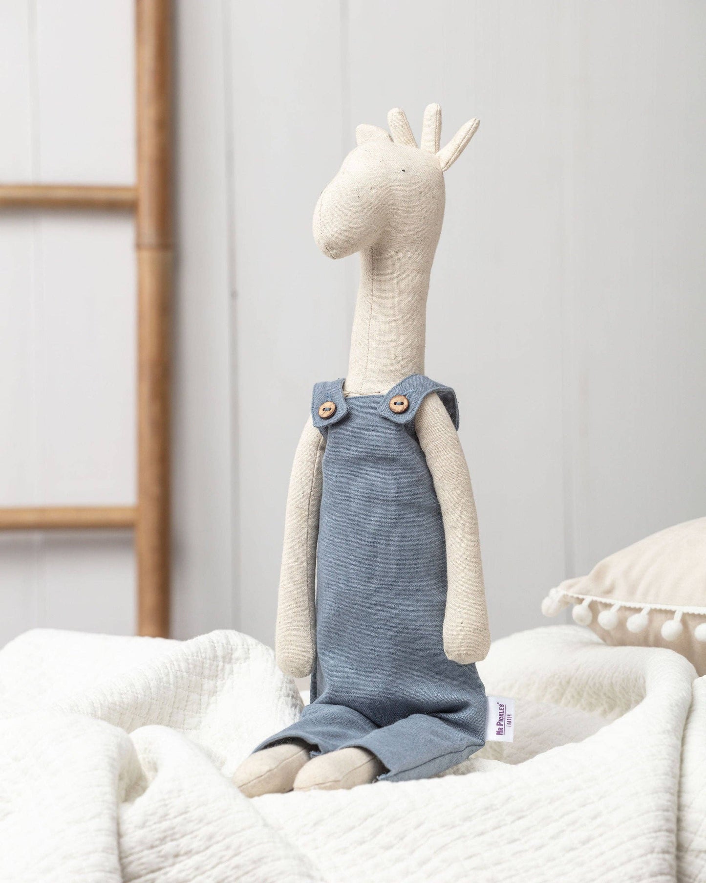 Gerald the Giraffe soft toy, a sustainable and lovable companion for children, sitting with his adventure backpack.