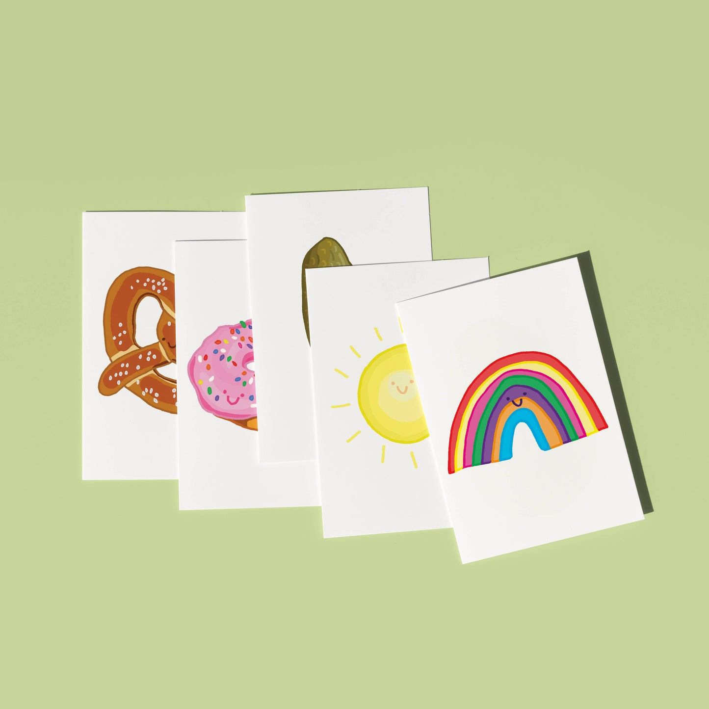 A mini greeting card with a hand-drawn illustration of a colourful rainbow with a smiley face, blank inside, and a brown kraft envelope. Illustrated and printed in the UK by You've got Pen on your Face.