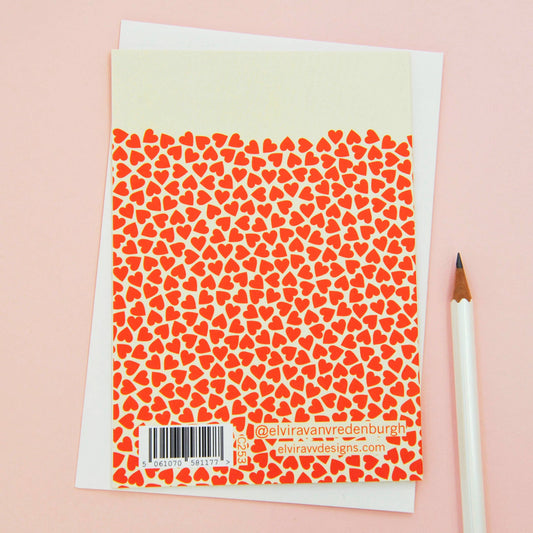 Close-up of UK-made Sustainable Engagement Love Greetings Card, showing tangerine red heart detail on 350gsm matt card.