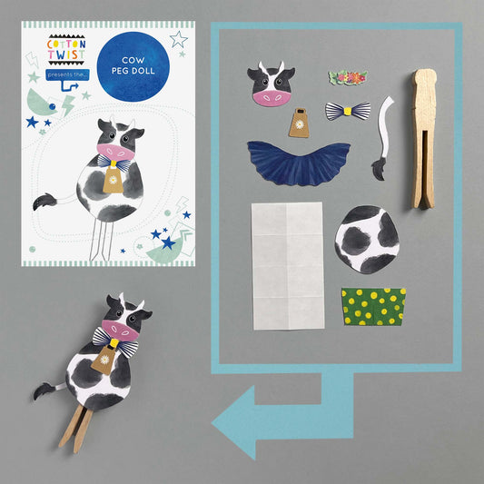 Child playing with finished Make Your Own Cow Peg Doll