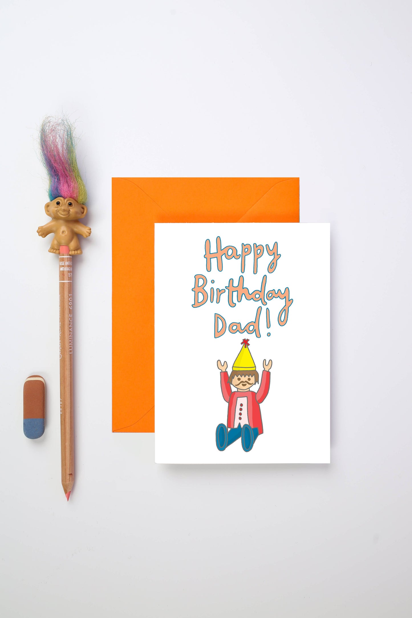 Celebrate Dad’s special day with a playful and nostalgic birthday card. Featuring a hand-drawn illustration of a beloved retro toy figure, this design perfectly captures the charm of the past while bringing a smile to the present. The cheerful message on the front reads "Happy Birthday Dad!" making it an ideal way to honour a doting dad or fabulous father figure.