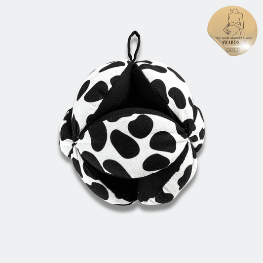Close-up of Etta Loves Dalmatian sensory ball, showing segmented design for easy baby grasping and organic cotton texture.