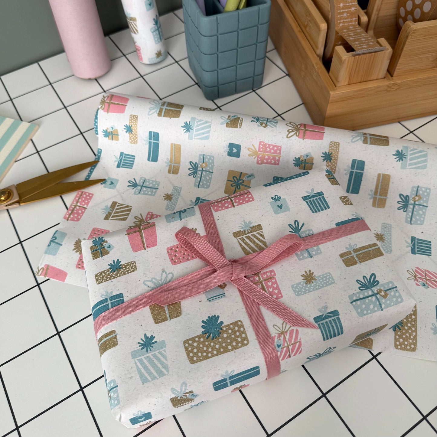 5m roll of eco-friendly present-design wrapping paper, 500mm wide, 100% recycled kraft, sustainably sourced, recyclable.