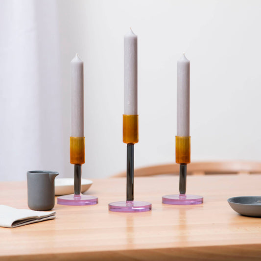 Medium glass candlestick holder in smoke and amber on dining table