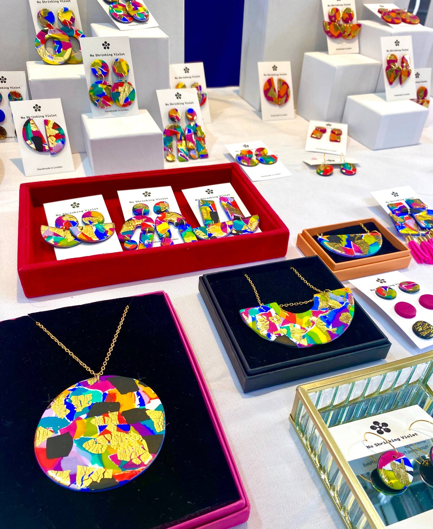 Model wearing 80s multicoloured polymer clay stack earrings, showcasing size and drop