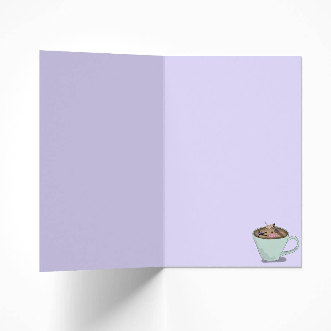 Inside view of the coffee lover birthday card, showing a subtle lilac hue and a small matching illustration of women bathing in coffee in the bottom right corner.