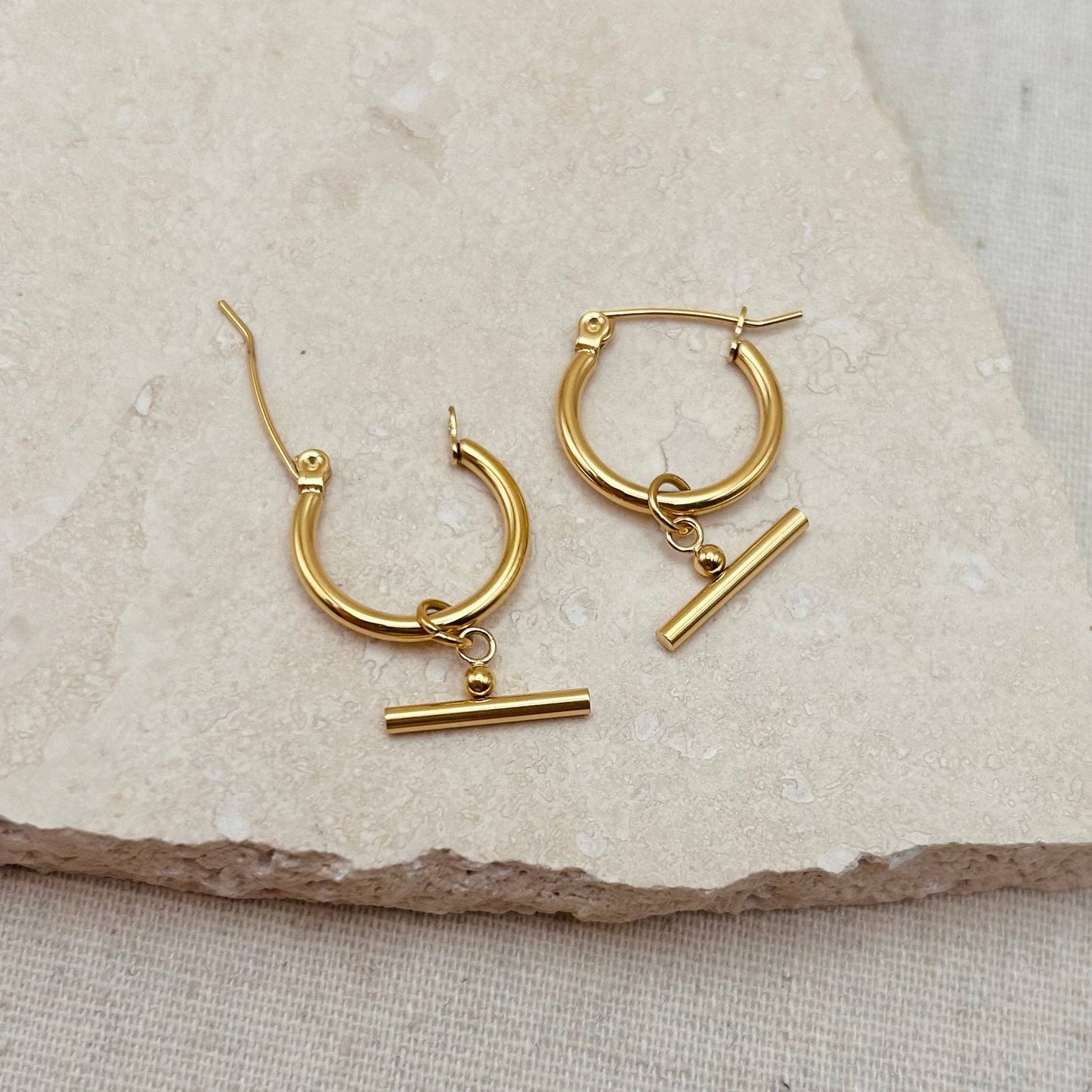 Pair of Little Nell lightweight gold bar hoops with removable charm, waterproof and hypoallergenic