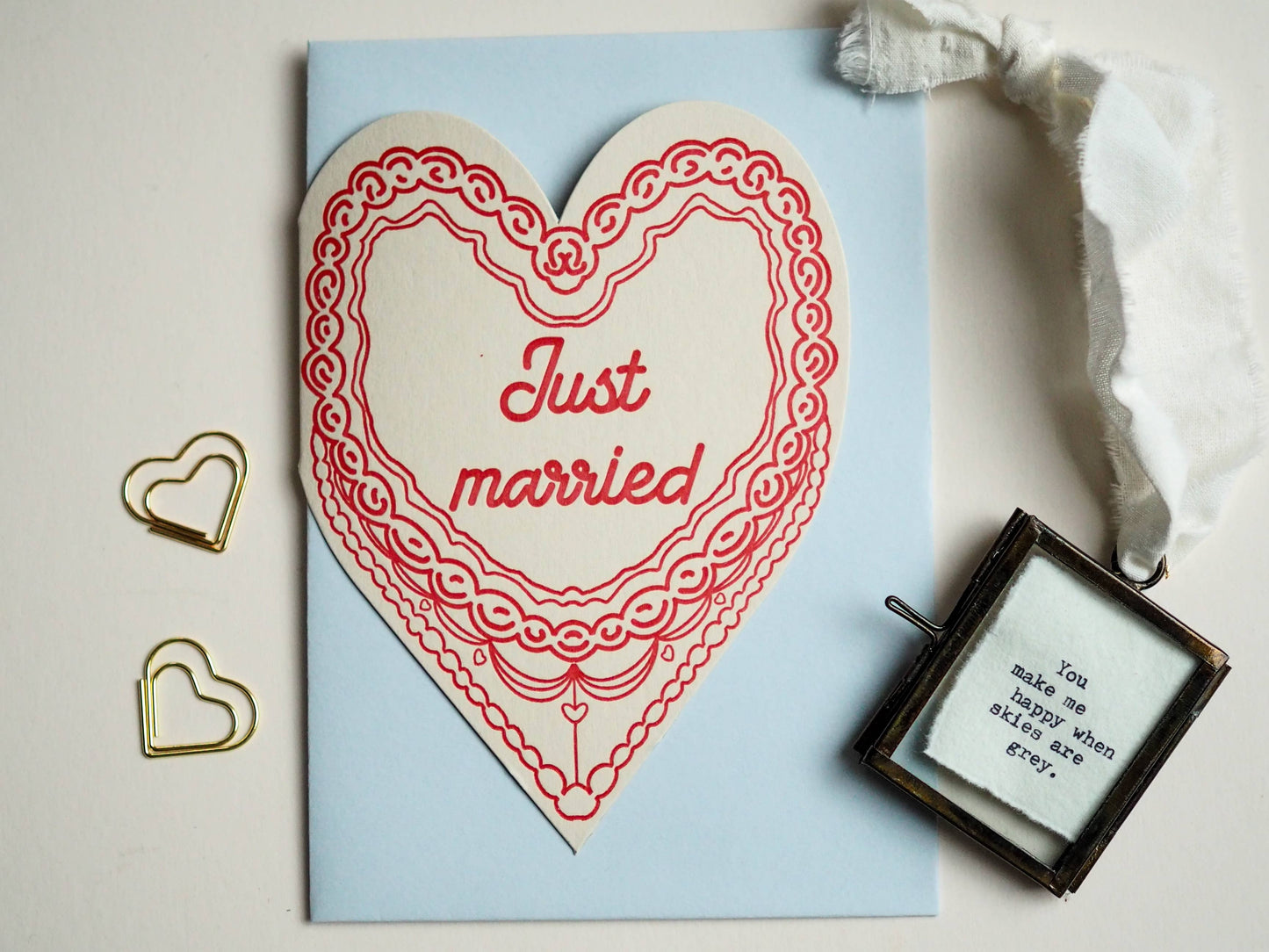 A letter press greeting card featuring a hand drawn retro cake in red and the words Just married.