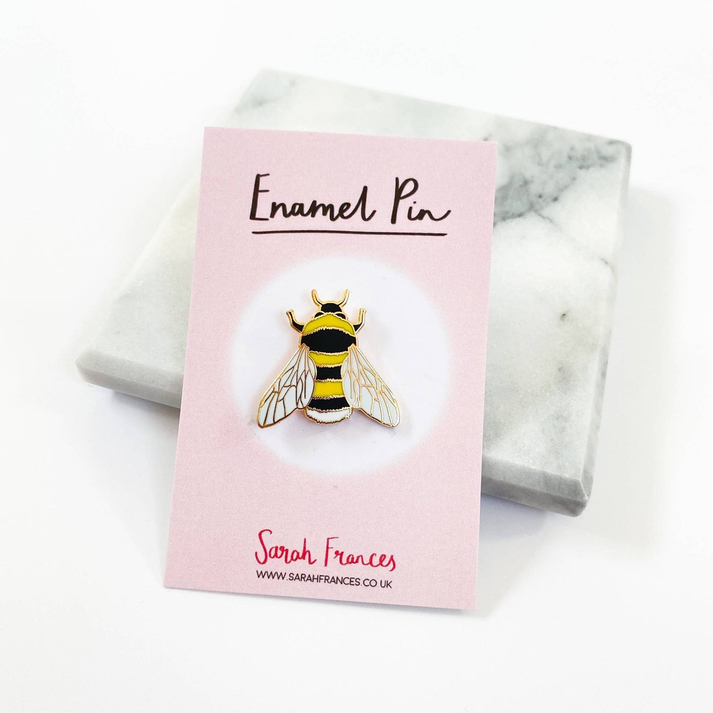 Based on one of Sarah Frances's original watercolour illustrations, this Bee Enamel Pin is perfect for any bee lovers! It will add some serious pin flair to any jacket, bag or cardigan. Made with shiny rose gold metal and hard enamel, the pin measures 1 inch (25mm) at it's widest point. It has a black rubber clutch on the back and will be presented on a small cardboard backer.
