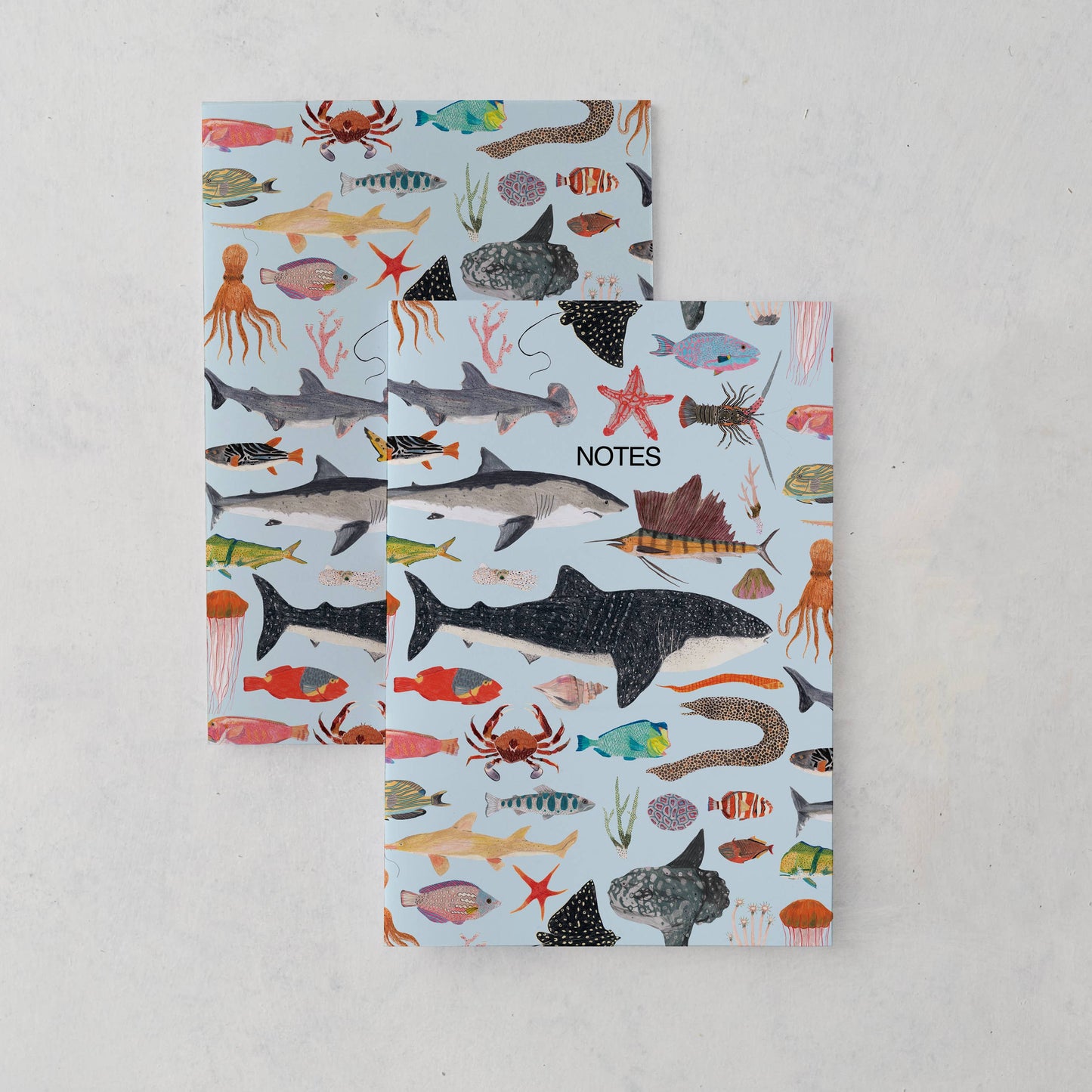 A5 sea life notebook featuring hand-illustrated ocean animals on a blue background, matte finish cover, and kraft belly band. Eco-friendly, UK made.