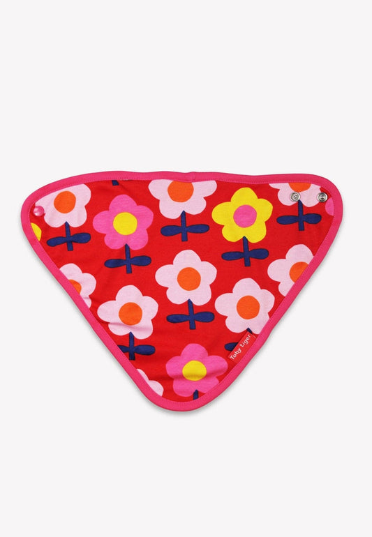 Close-up of organic cotton pink floral fabric on baby dribble bib