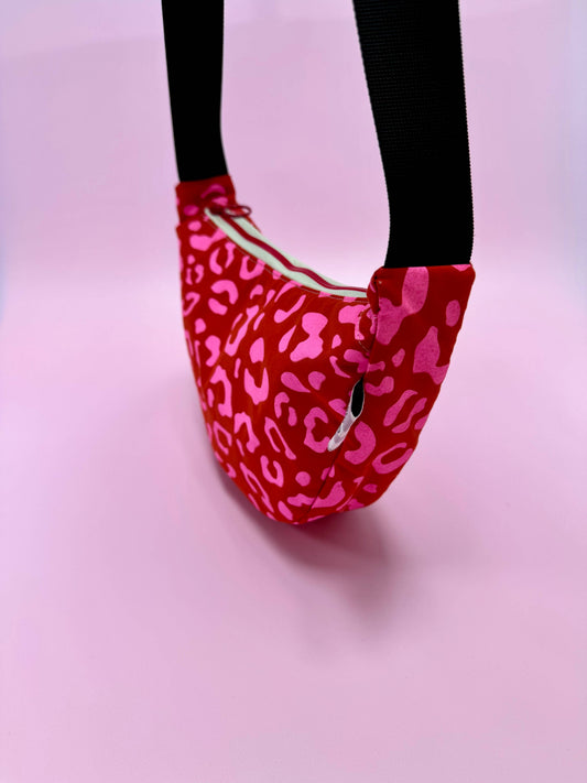 Close up of handprinted leopard pattern on red waxed canvas