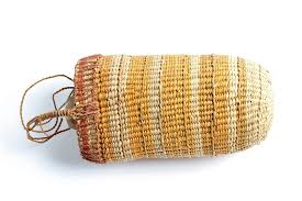 Handwoven basket, showcasing the traditional artistry that inspired the earrings.