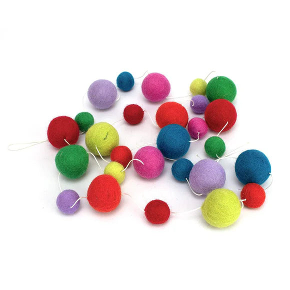 Rainbow pompom decorative garland. Hang this handmade garland on walls or doorways for a colourful party decoration.
This fun pompom garland is a great gift for those who value ethical and handmade décor, and the preservation of cultures. The felt used to craft this garland was made from the finest material: 100% pure New Zealand wool, making it non-allergic and non-toxic.