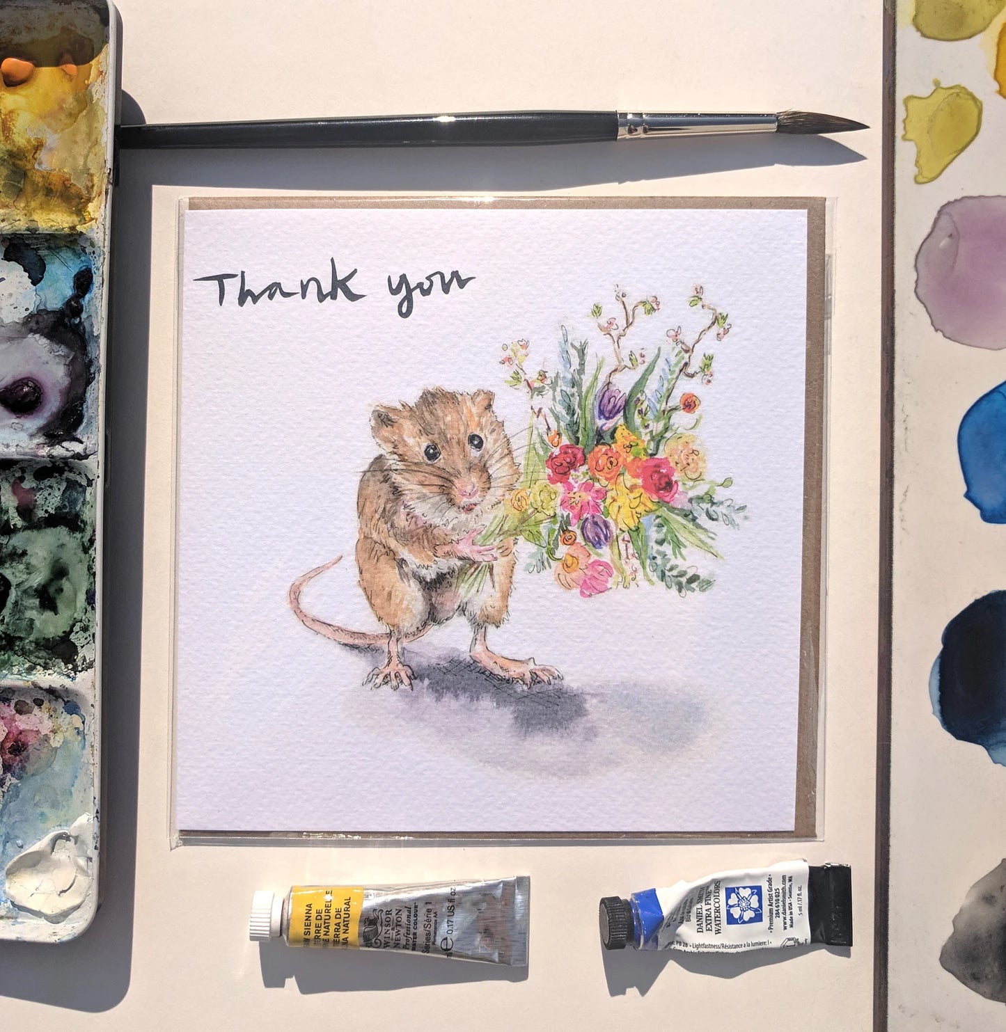 Charming harvest mouse holding a floral bouquet on a 'Thank You' greeting card by artist Jessica Kendrew, textured finish.