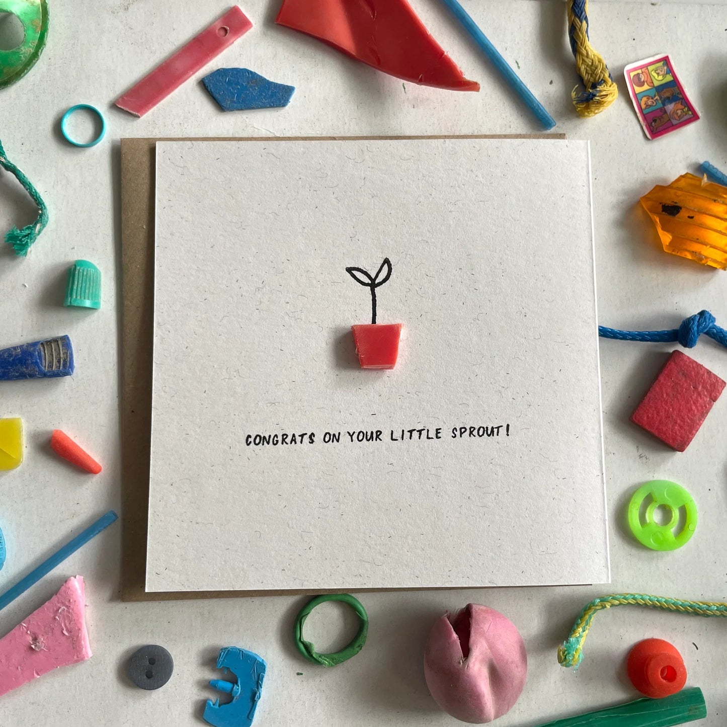 Unique 'Little Sprout' new baby card with plant pot made from recycled plastic, blank inside with recycled brown envelope.