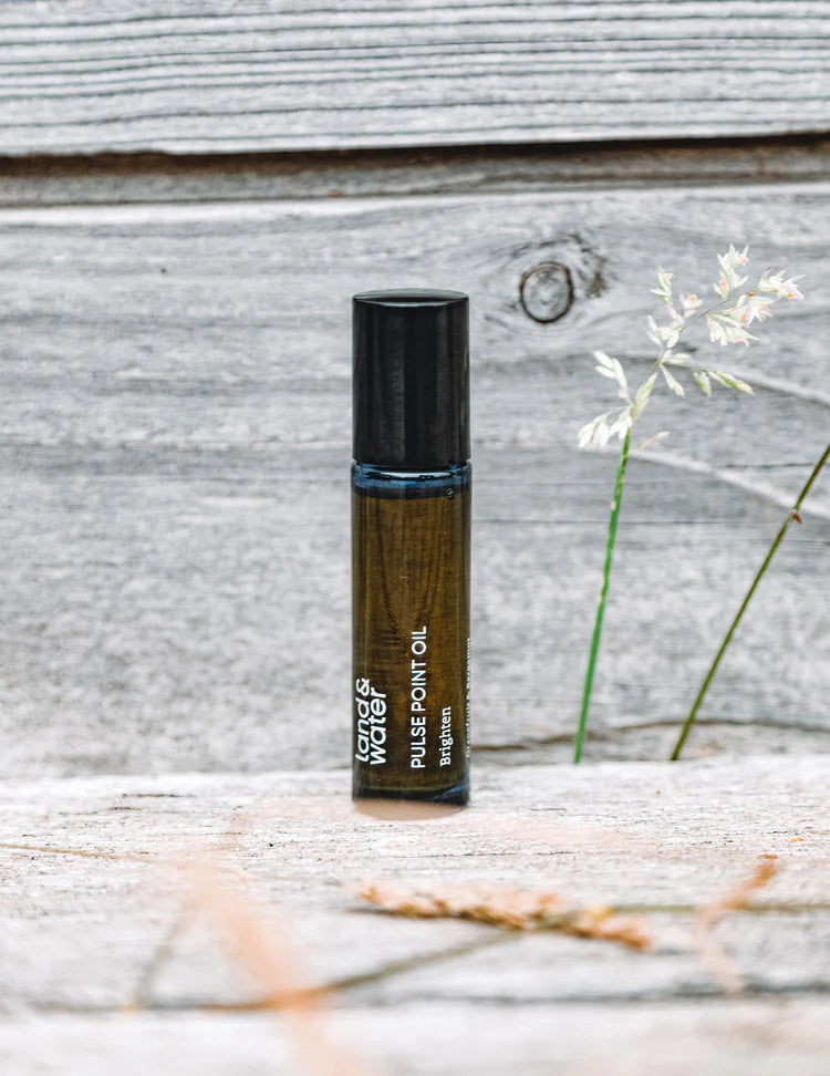 Close-up of Brighten Pulse Point Oil roller bottle, highlighting natural ingredients and eco-friendly design. Perfect for on-the-go mood boosting.
