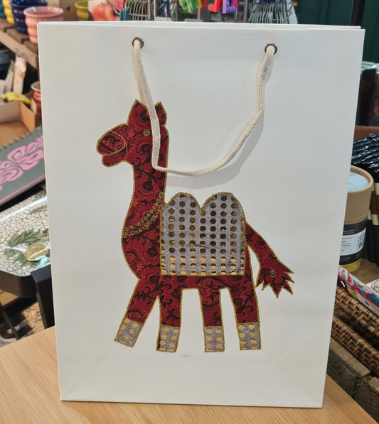 Close-up of the unique camel design on a large ethical gift bag, showcasing sari fabric details.