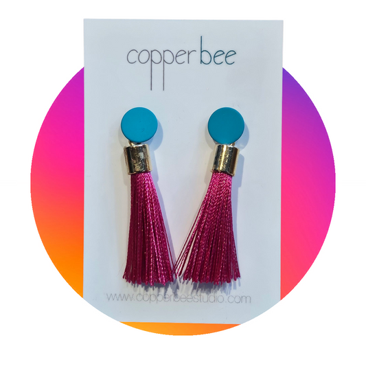 Close-up of bright silk tassels and powder-coated stud detail on Carnival Earrings