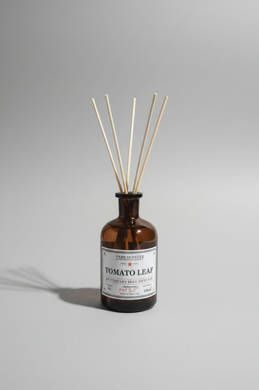 Parkminster Tomato Leaf diffuser in a brown apothecary glass bottle .