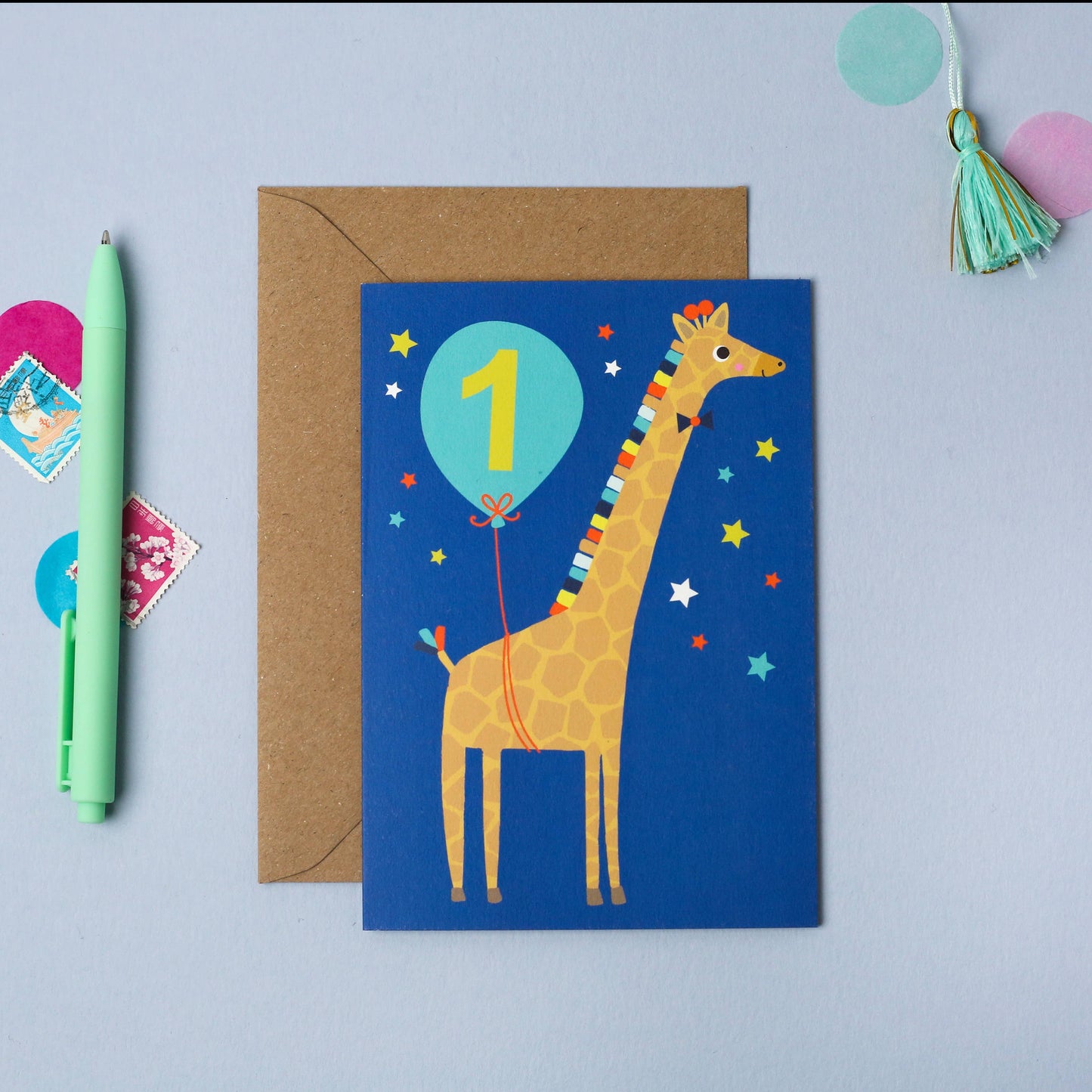 Age 1 blue giraffe birthday card for kids, made from sustainably sourced card with a kraft envelope