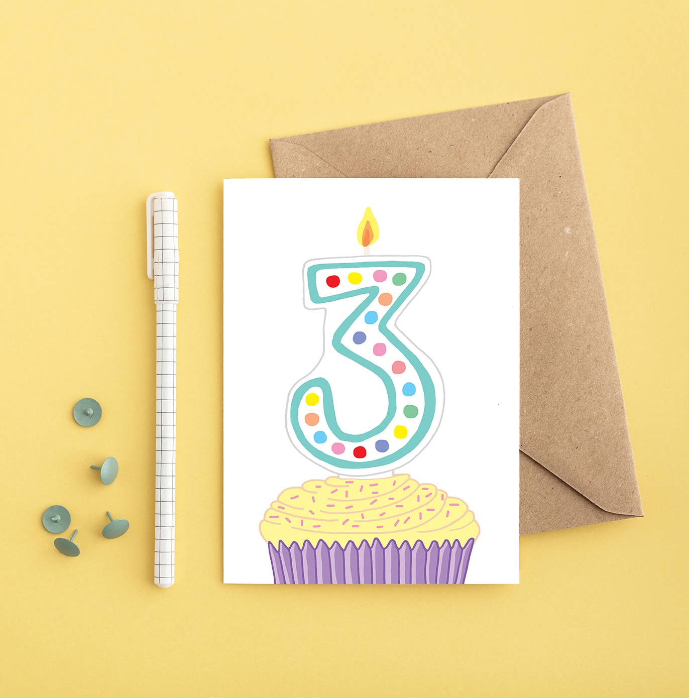 Brightly coloured cupcake with a number 3 candle on a 3rd birthday greeting card, hand-drawn and printed in the UK on sustainably sourced paper.