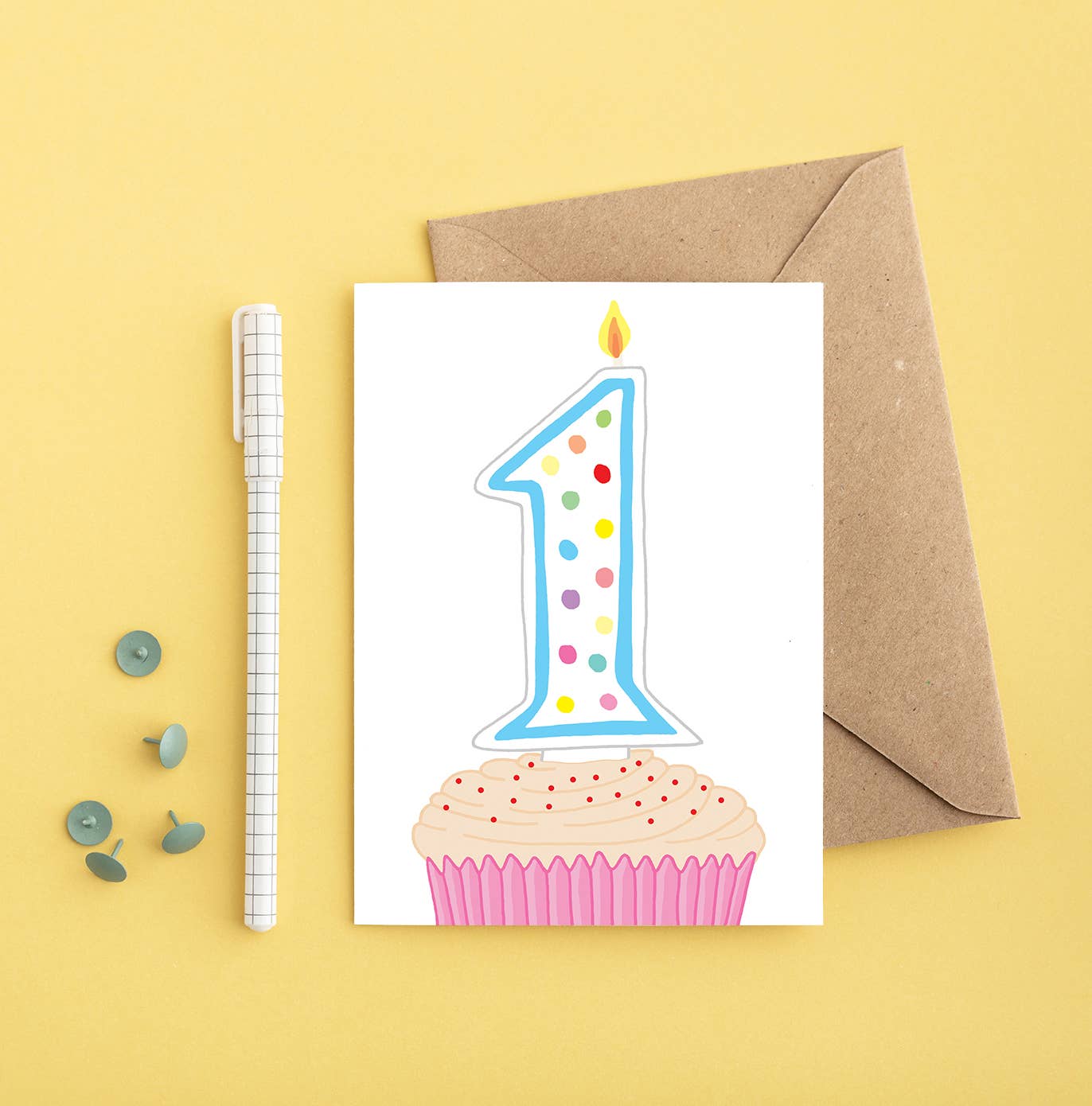 First birthday card featuring a brightly coloured cupcake with a number 1 candle, perfect for a baby's milestone celebration.